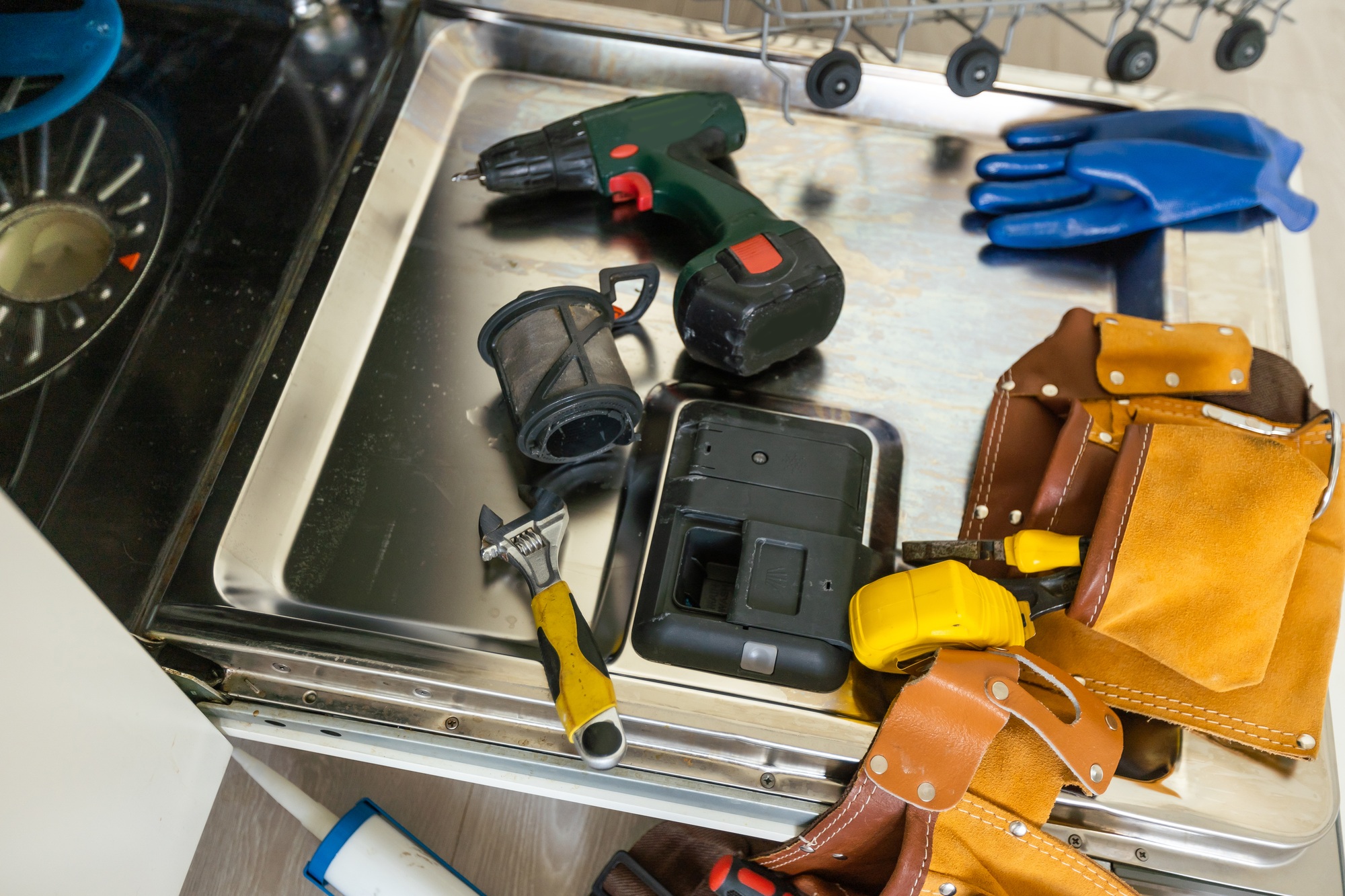dishwasher door removed for repair, breakdown of kitchen appliances.